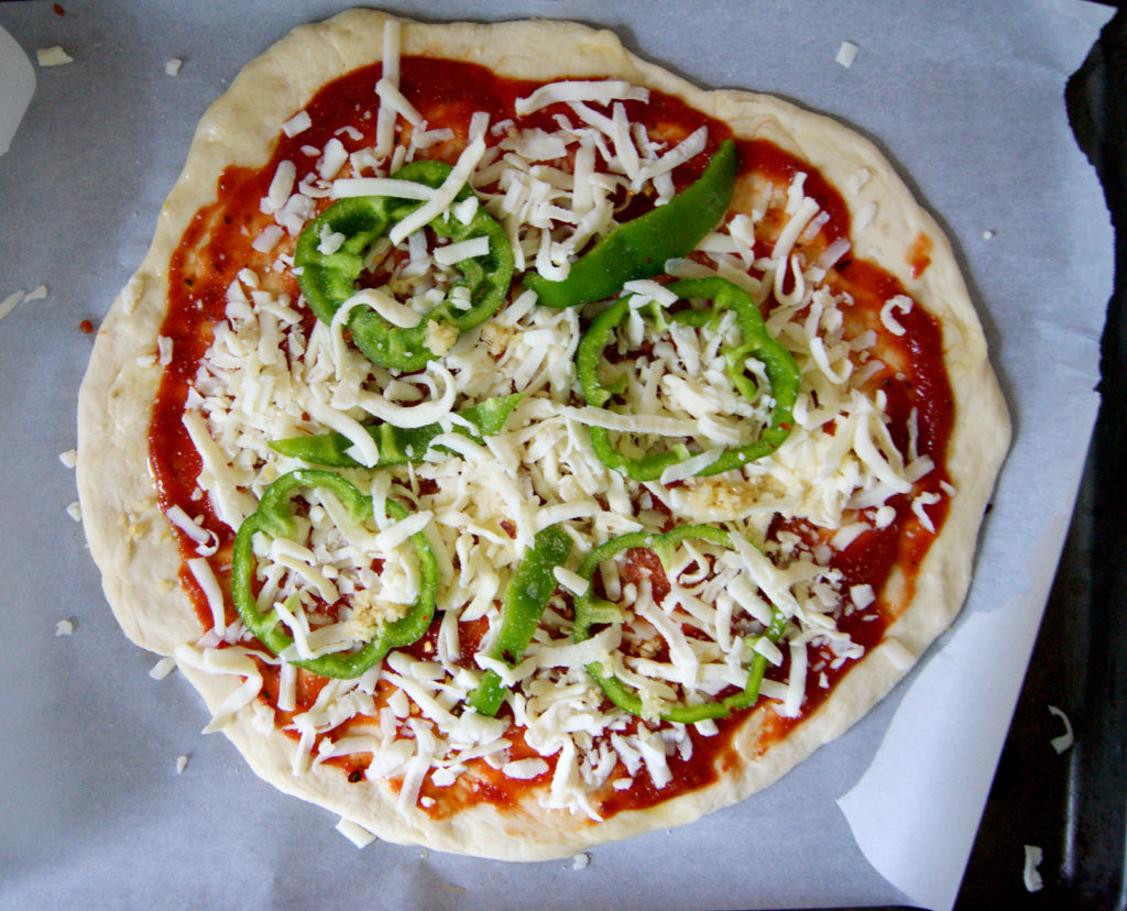 Pizza dough with green pepper toppings